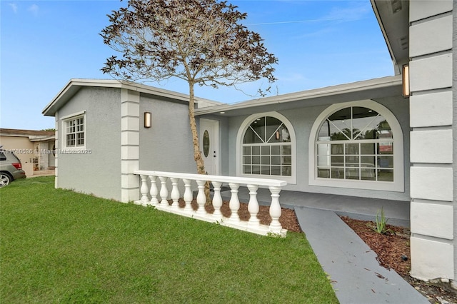 7320 Biltmore Blvd, Miramar, FL 33023 - view of front of property with a front yard, stucco siding, and covered porch