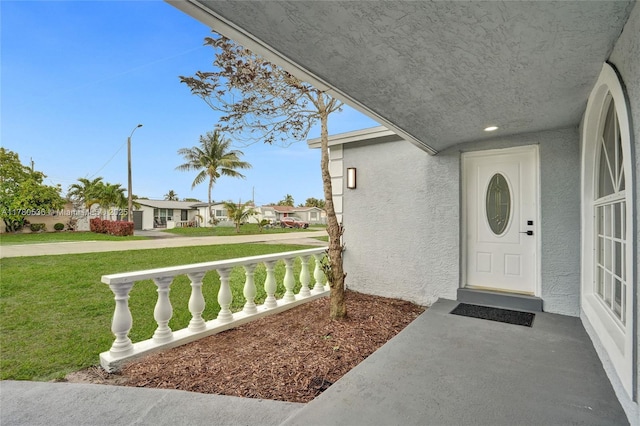 7320 Biltmore Blvd, Miramar, FL 33023 - doorway to property featuring stucco siding, a yard, covered porch, and a residential view