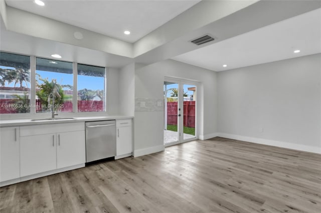 7320 Biltmore Blvd, Miramar, FL 33023 - kitchen featuring dishwasher, a sink, light countertops, baseboards, and white cabinets