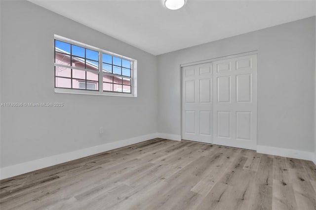 7320 Biltmore Blvd, Miramar, FL 33023 - unfurnished bedroom with a closet, wood finished floors, and baseboards