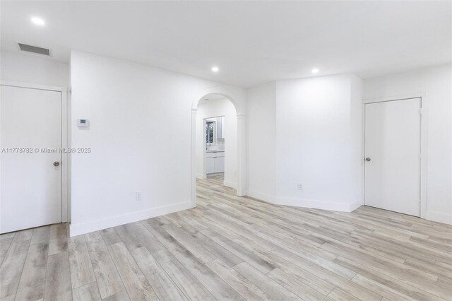 6440 SW 20th St, Miramar, FL 33023 - spare room with arched walkways, recessed lighting, light wood-type flooring, and baseboards