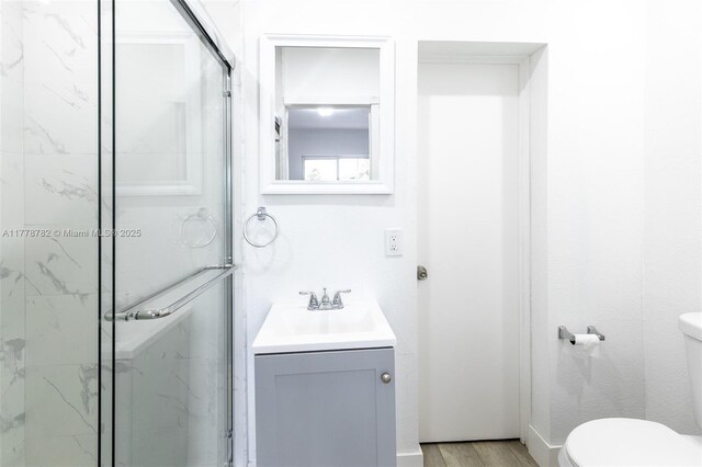 6440 SW 20th St, Miramar, FL 33023 - full bathroom with a marble finish shower, toilet, vanity, and wood finished floors