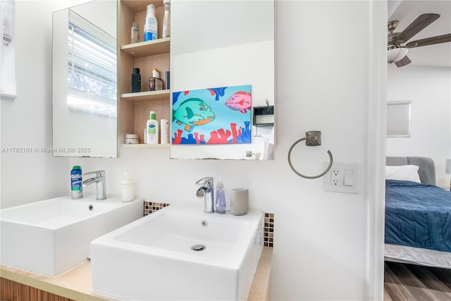 ensuite bathroom with ensuite bathroom, a sink, and a ceiling fan