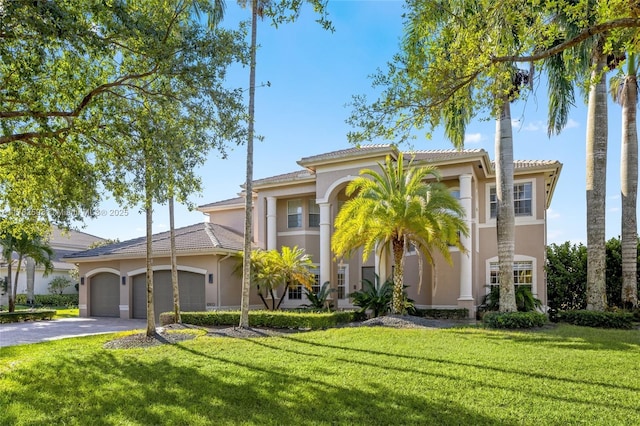 10972 Pine Lodge Trl, Davie, FL 33328 - mediterranean / spanish-style house featuring an attached garage, a tiled roof, aphalt driveway, and stucco siding