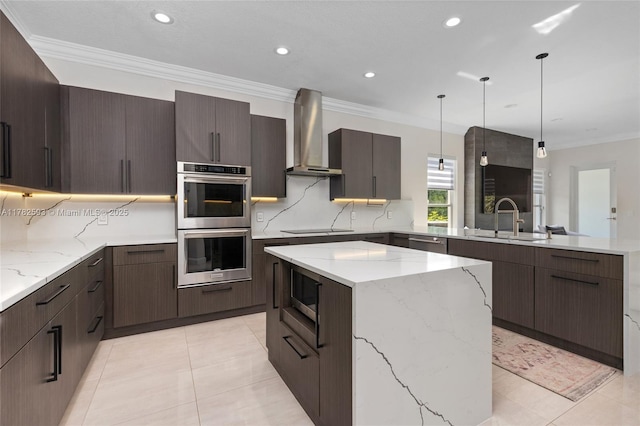 10972 Pine Lodge Trl, Davie, FL 33328 - kitchen featuring wall chimney range hood, recessed lighting, a peninsula, stainless steel appliances, and a sink