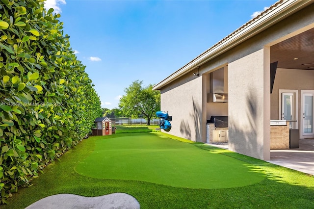 10972 Pine Lodge Trl, Davie, FL 33328 - view of yard with an outdoor kitchen, a patio area, and fence