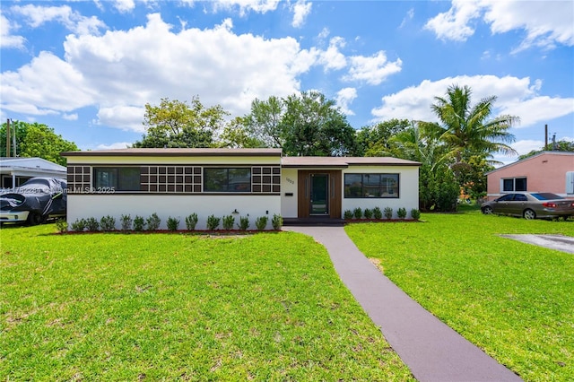1000 NW 198th St, Miami Gardens, FL 33169 - view of front of home with stucco siding and a front lawn