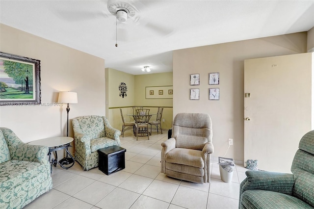living area featuring ceiling fan and light tile patterned flooring