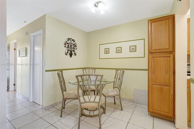 dining area with light tile patterned floors and baseboards