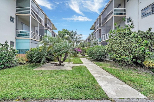 view of property's community with a lawn