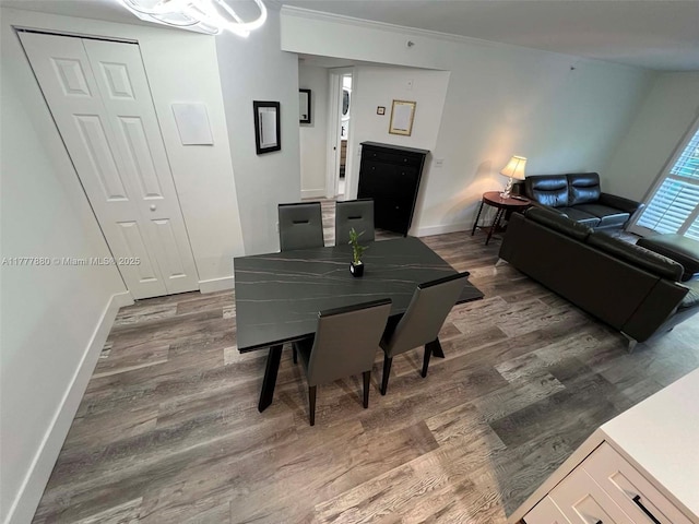 dining area with baseboards and wood finished floors