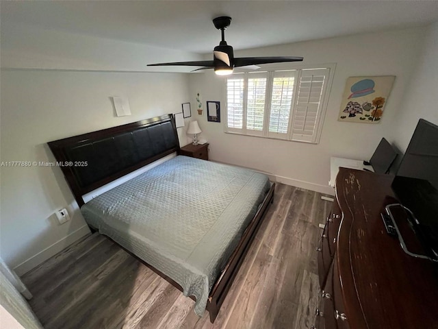bedroom featuring baseboards, ceiling fan, and wood finished floors