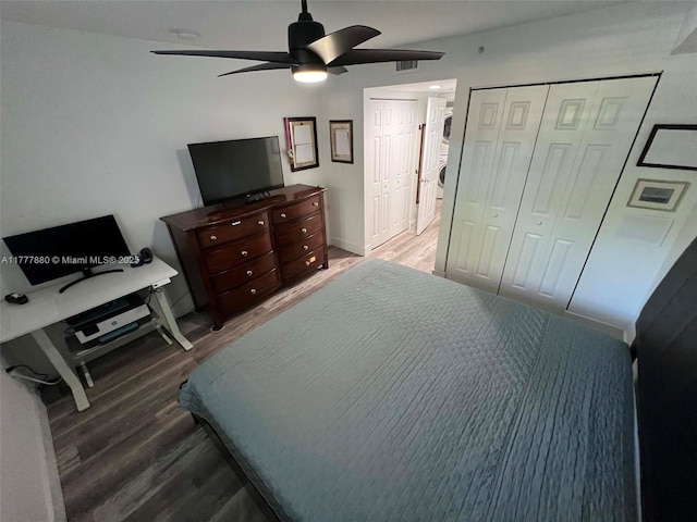 bedroom featuring visible vents, a ceiling fan, a closet, and wood finished floors