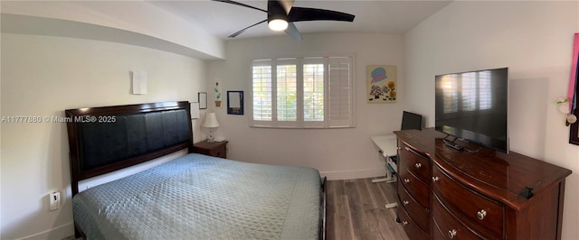 bedroom with baseboards, a ceiling fan, and wood finished floors