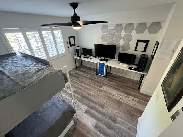 bedroom with baseboards, a ceiling fan, and wood finished floors
