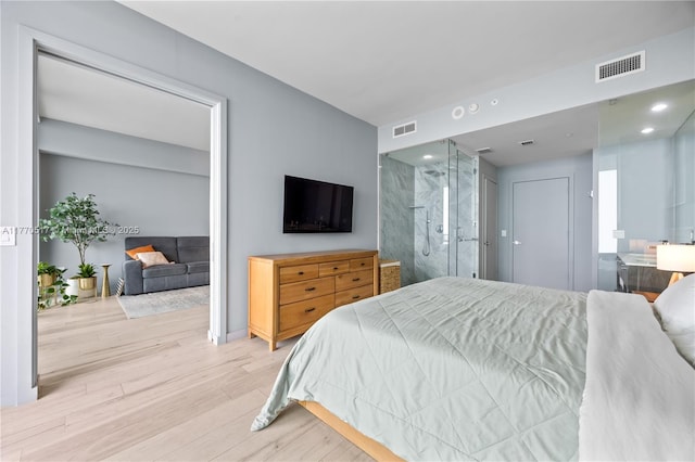 bedroom featuring wood finished floors and visible vents