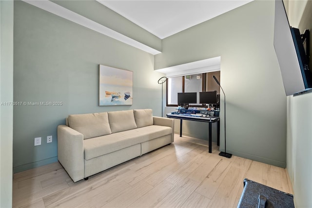 living room featuring wood finished floors and baseboards