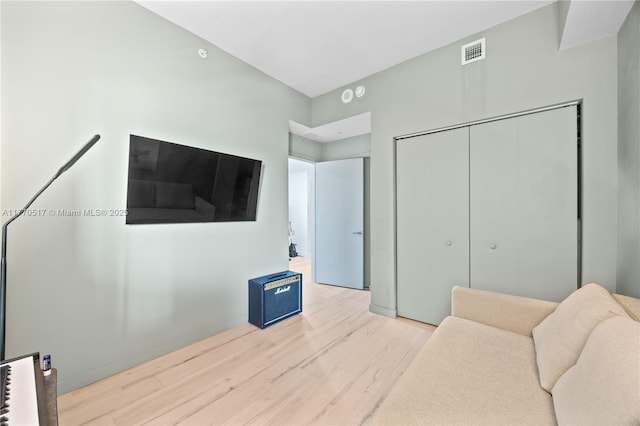 living area featuring wood finished floors and visible vents