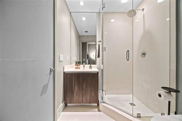 full bathroom featuring vanity, tile patterned flooring, recessed lighting, and a stall shower