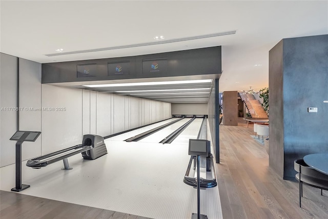 interior space with a bowling alley and wood finished floors