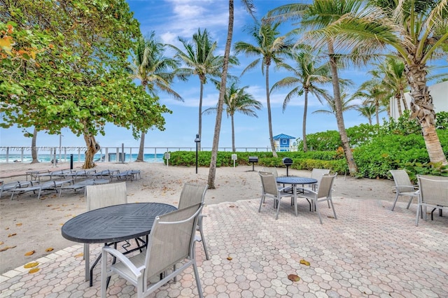 3001 S Ocean Dr Unit 1507, Hollywood, FL 33019 - view of patio with a beach view, fence, a water view, and outdoor dining area