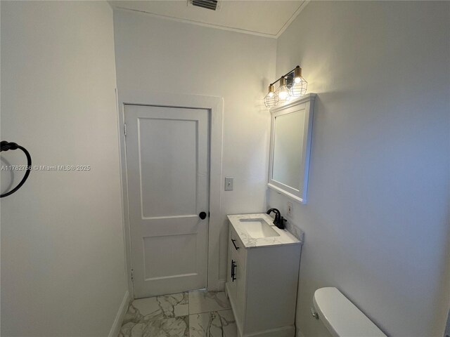 bathroom with marble finish floor, visible vents, toilet, vanity, and baseboards