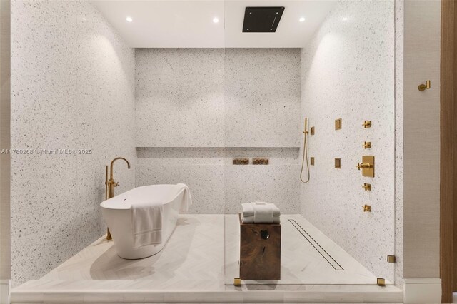 bathroom with recessed lighting and a soaking tub