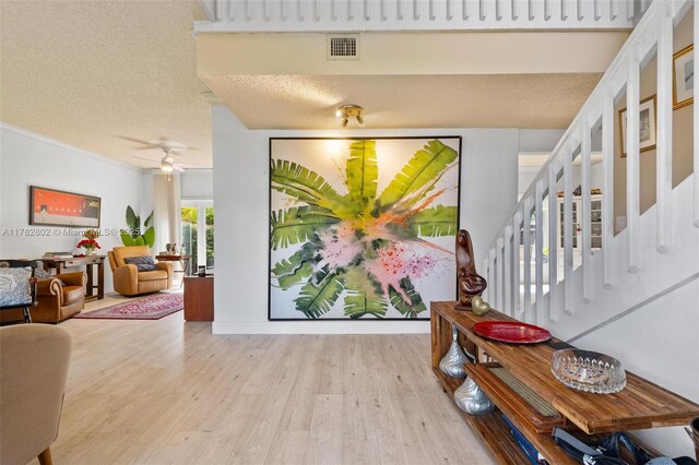 4471 SW 154th Ct, Miami, FL 33185 - entrance foyer featuring wood finished floors, a textured ceiling, stairs, and ceiling fan