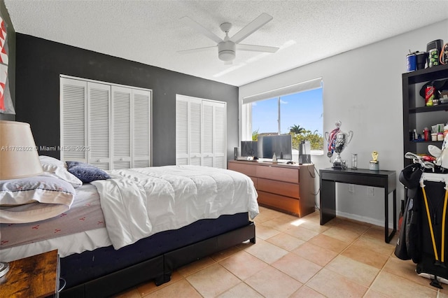 4471 SW 154th Ct, Miami, FL 33185 - bedroom with two closets, a textured ceiling, light tile patterned floors, and a ceiling fan