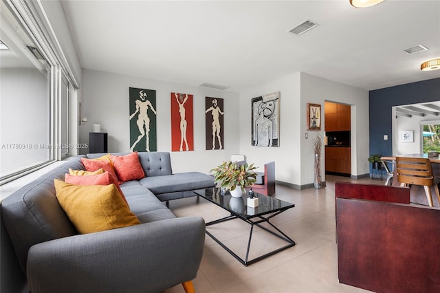living room featuring baseboards and visible vents