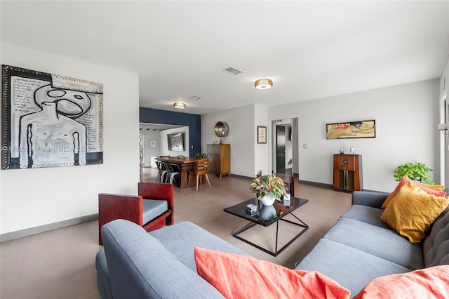 living area with visible vents and baseboards