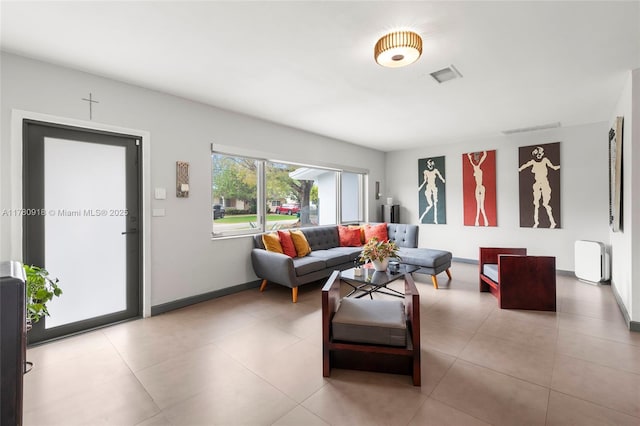 tiled living area with visible vents and baseboards
