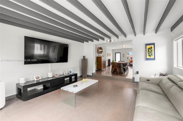 living room featuring beam ceiling and tile patterned flooring