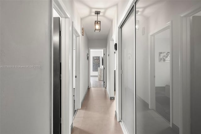 hall with light tile patterned floors