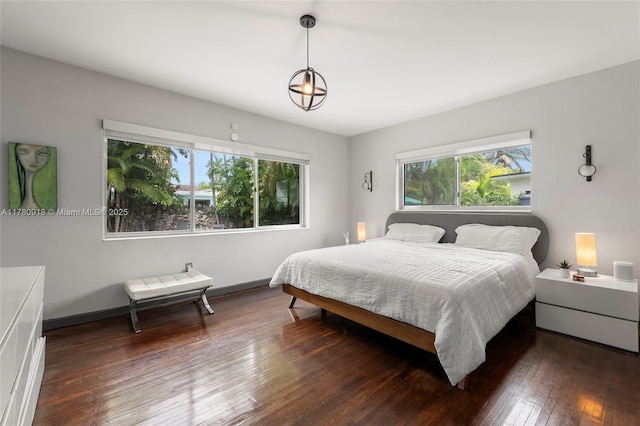 bedroom with hardwood / wood-style flooring and baseboards