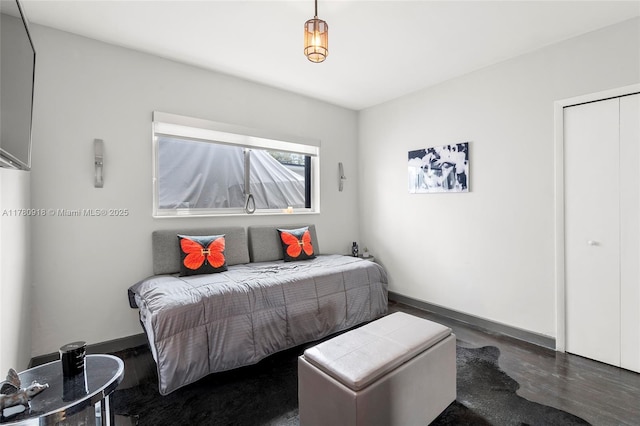 bedroom featuring baseboards and wood finished floors
