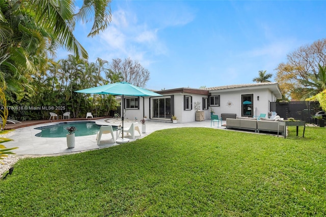 back of house with fence, a yard, a patio, a fenced in pool, and an outdoor hangout area