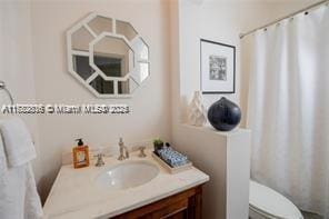 bathroom featuring vanity and toilet