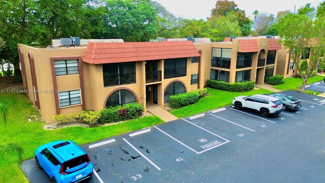 view of property featuring uncovered parking