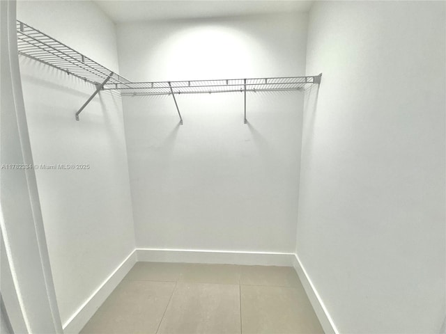 spacious closet featuring light tile patterned flooring