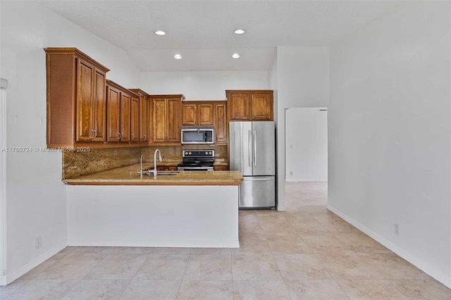 971 NW 89th Ave, Plantation, FL 33324 - kitchen featuring stainless steel appliances, brown cabinets, a sink, and backsplash