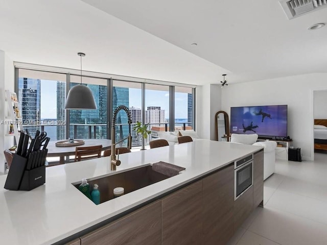 1300 S Miami Ave Unit 2001, Miami, FL 33130 - kitchen with stainless steel microwave, modern cabinets, light countertops, and open floor plan