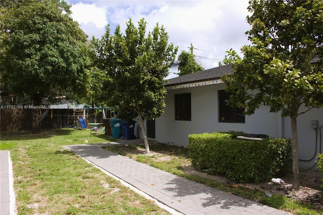 view of yard with fence and a playground