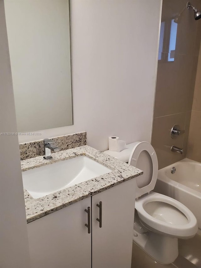 bathroom with toilet, vanity, and tub / shower combination