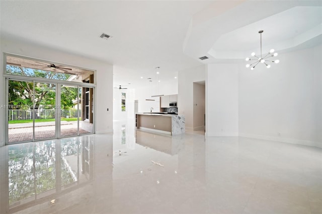 1807 Victoria Pointe Cir, Weston, FL 33327 - unfurnished living room with a chandelier, baseboards, a ceiling fan, and a raised ceiling