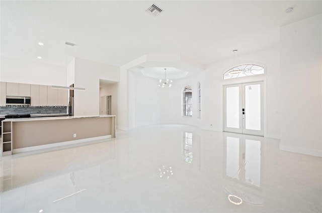 1807 Victoria Pointe Cir, Weston, FL 33327 - unfurnished living room featuring light tile patterned floors, a chandelier, baseboards, and french doors