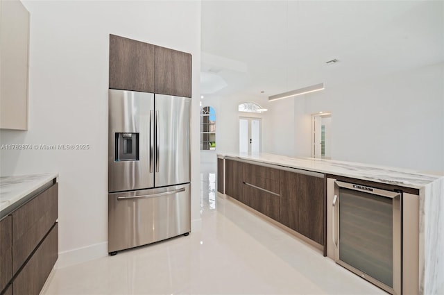 1807 Victoria Pointe Cir, Weston, FL 33327 - kitchen with stainless steel fridge with ice dispenser, modern cabinets, dark brown cabinetry, and wine cooler