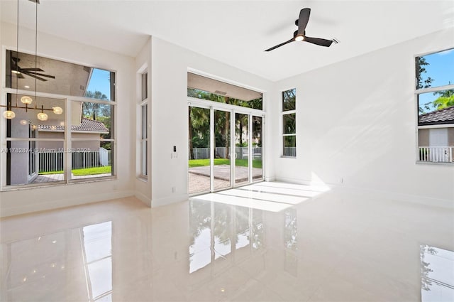 1807 Victoria Pointe Cir, Weston, FL 33327 - empty room featuring ceiling fan, plenty of natural light, tile patterned flooring, and baseboards