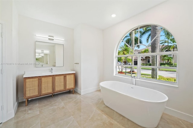 1807 Victoria Pointe Cir, Weston, FL 33327 - bathroom featuring baseboards, vanity, a freestanding bath, and recessed lighting
