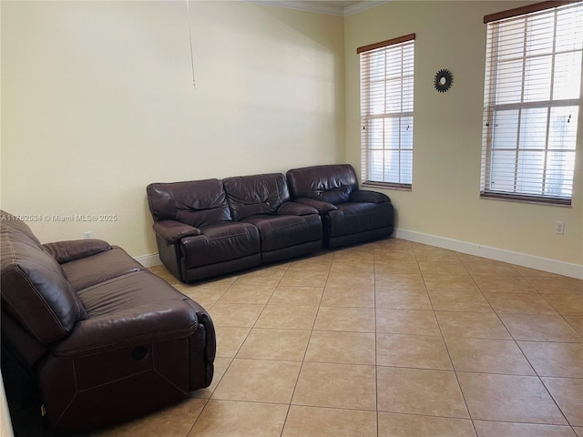 living area with light tile patterned flooring, baseboards, and ornamental molding
